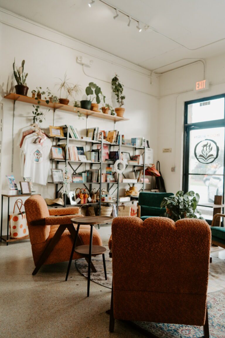 Cozy seating area and bookshelves inside BookBurn Cafe and Social, a welcoming LGBTQIA+ café in Orlando’s Milk District.