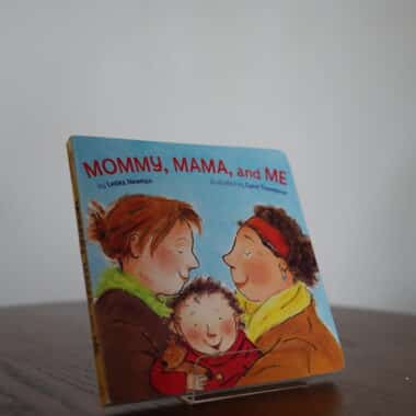 Mommy, Mama, and Me board book displayed on a table at BookBurn Cafe and Social