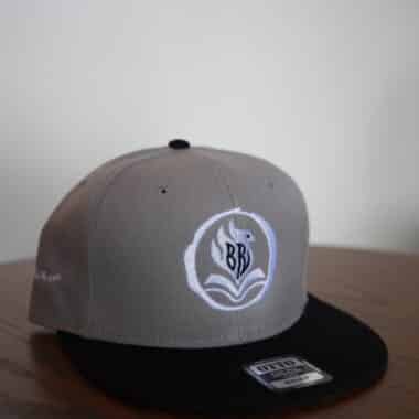 BookBurn logo flat brim hat displayed on table at BookBurn Cafe in Orlando