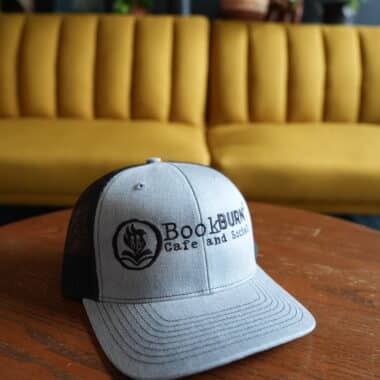 BookBurn Cafe and Social logo hat on table inside cafe in Orlando