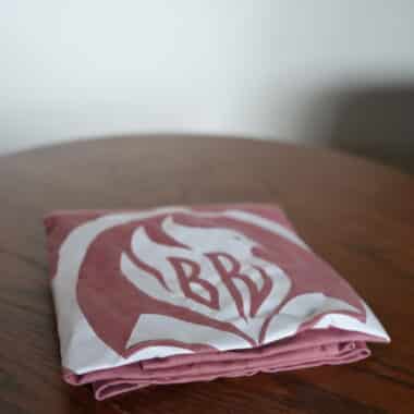 Folded BookBurn logo t-shirt on table at BookBurn Cafe and Social in Orlando