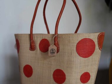 BookBurn polka dot tote bag with red handles displayed inside BookBurn Cafe in Orlando