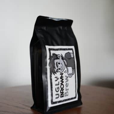 Ugly Brown Brew Philippine whole bean coffee bag on table at BookBurn Cafe in Orlando