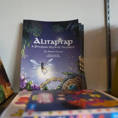 Alitaptap: A Philippine Myth of the Firefly book displayed on a shelf at BookBurn Cafe and Social.