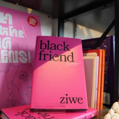 Black Friend Essays by Ziwe displayed on a bookshelf at BookBurn Cafe and Social