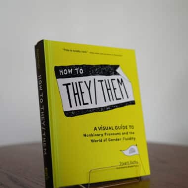 How to They Them book about nonbinary pronouns displayed on a table at BookBurn Cafe and Social